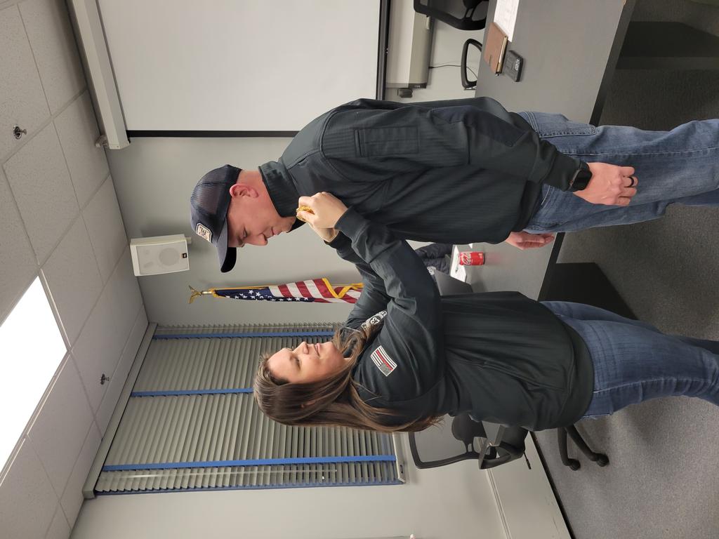 BC Seybert's badge being pinned on by this sister, Firefighter/EMT Liz Briggs.